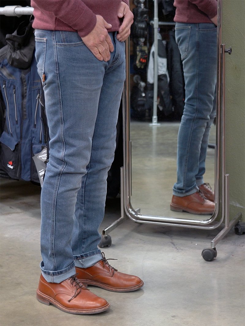 Customer standing in front of mirror wearing Rokkertech Tapered slim jeans